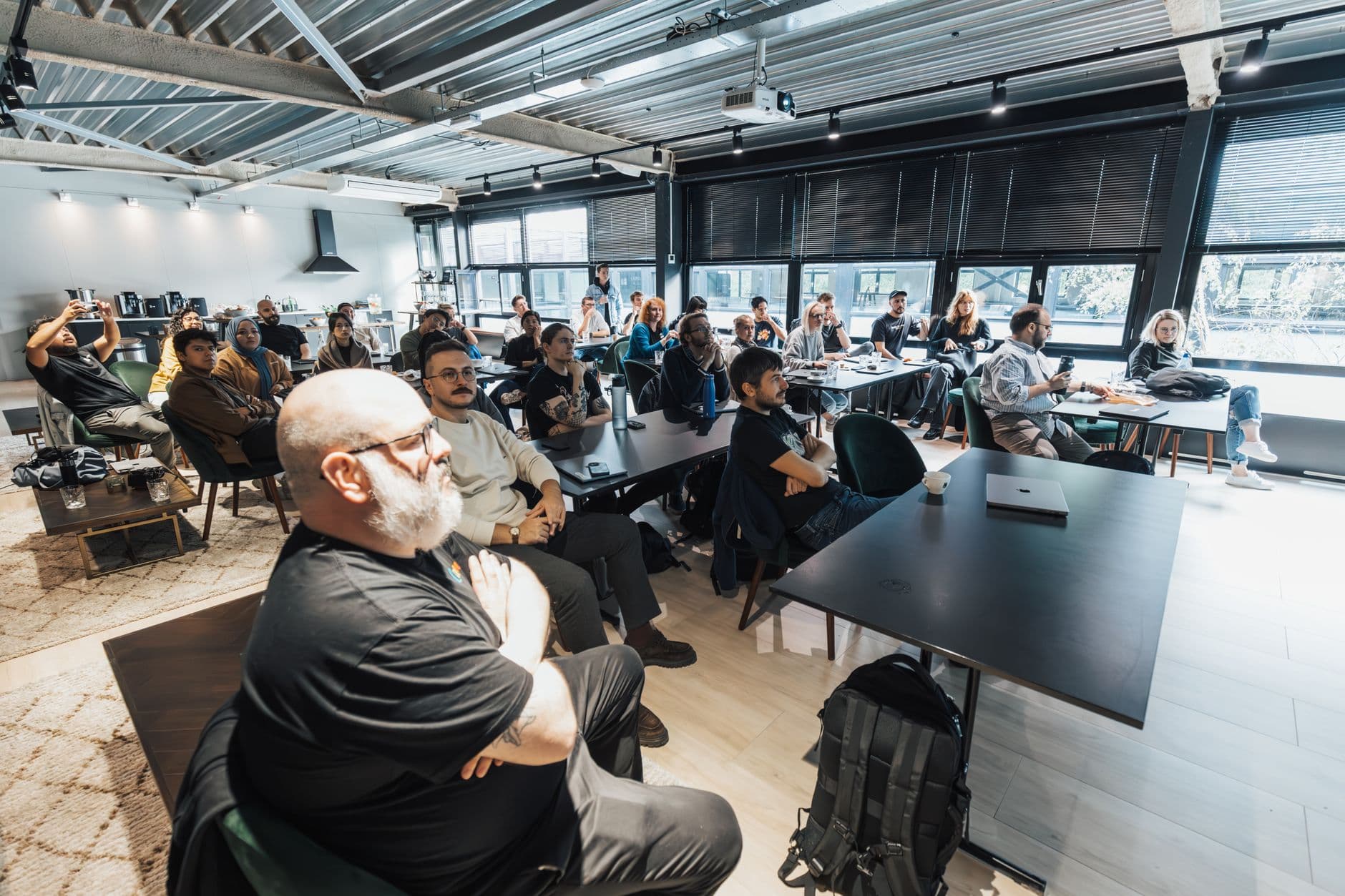 Participants attending a workshop in a bright training venue