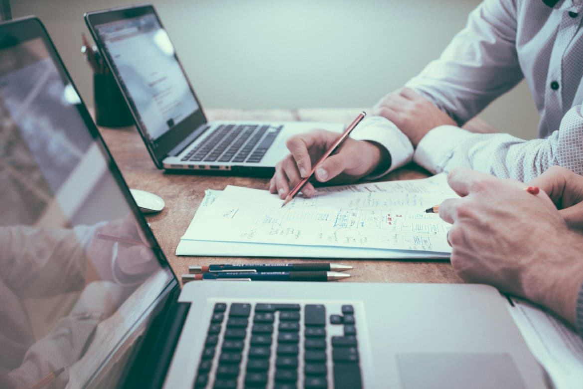 Consultants reviewing documents together at a desk
