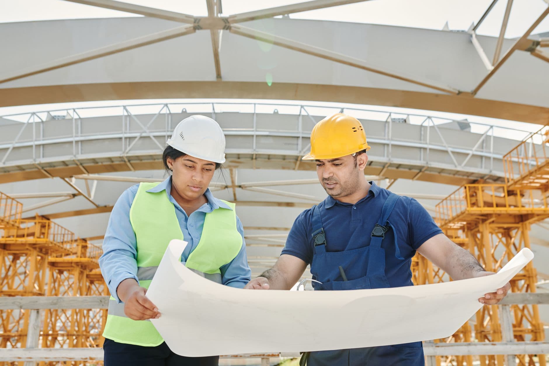 Professionals review plans at a construction site