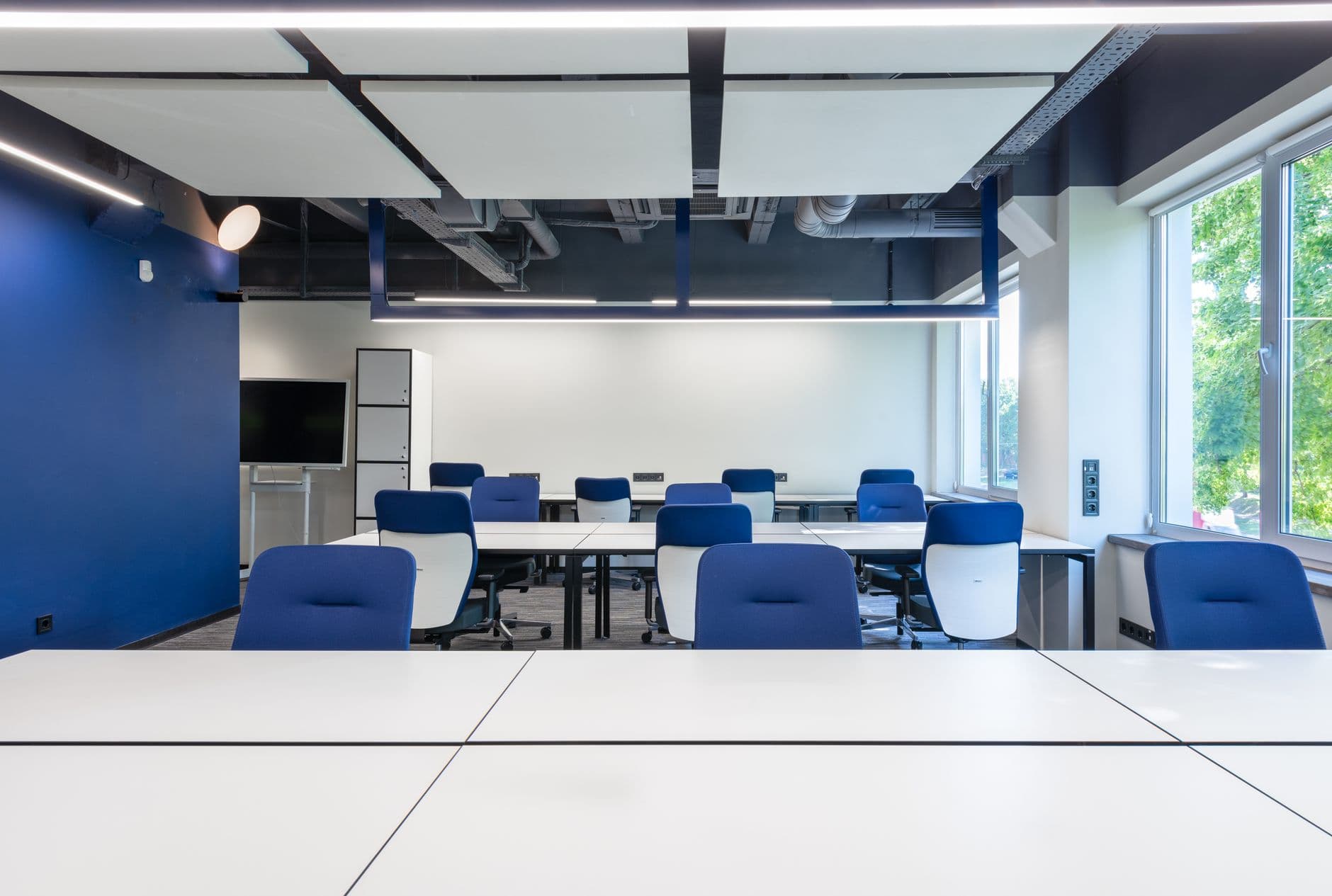Modern office with comfortable seating, shared desks and natural light